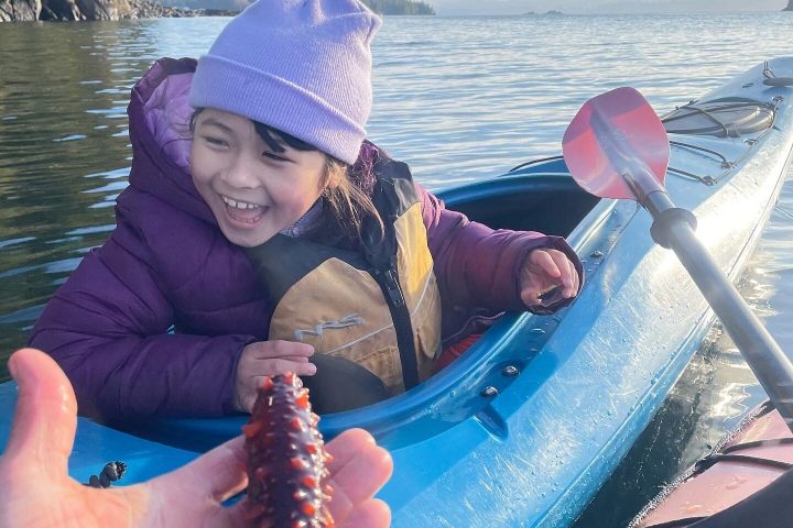 Little girl and sea cucumber