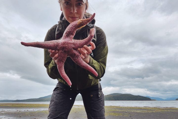 a person standing next to a body of water