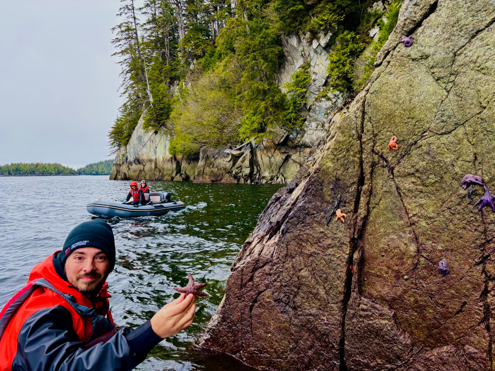 a man standing next to a body of water